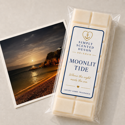 A packaged bar of Simply Scented Devon Brixham Moonlit Tide luxury home fragrance wax melts, shown next to a beach sunset photo print on a light gray surface.