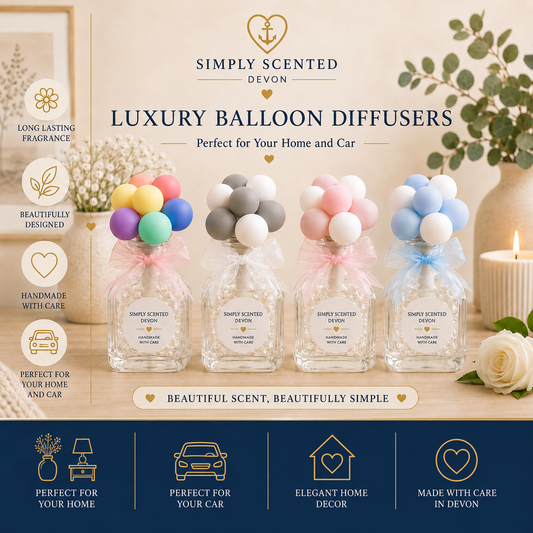 Four clear glass balloon diffusers filled with fragrance and topped with pastel balloon clusters, displayed on a tabletop with decorative flowers, a candle, and branding text for Simply Scented Devon.